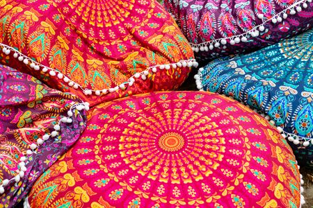 Bright colorful handmade ethnic traditional pillows background selling on a local asian market.