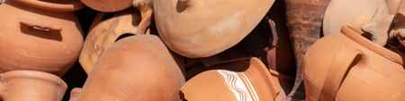 Many ceramic handmade utensils, made of clay, close up.