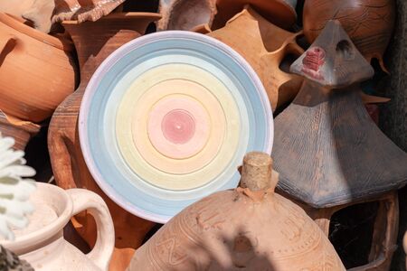 Many ceramic handmade utensils, made of clay, close up.