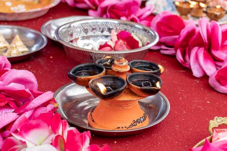 Traditional south indian ceramic oil lamp 'Nilavilakku' on wedding ceremony, Nilavilakku is lighted before starting the rituals.の写真素材