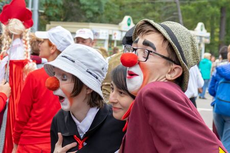 Moscow, Russia - September 14, 2019: Clown festival in the city, clowns in colorful clothes and with a bright makeup communicate with children and make funny facesのeditorial素材