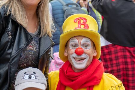 Moscow, Russia - September 14, 2019: Clown festival in the city, clowns in colorful clothes and with a bright makeup communicate with children and make funny facesのeditorial素材