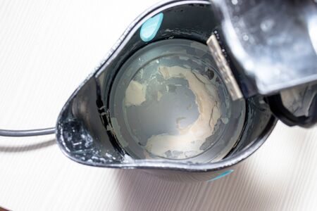 Limescale, lime scale in old kettle in kitchen. A white, chalky residue of calcium carbonate. Household appliances repair caused by hard water.の写真素材
