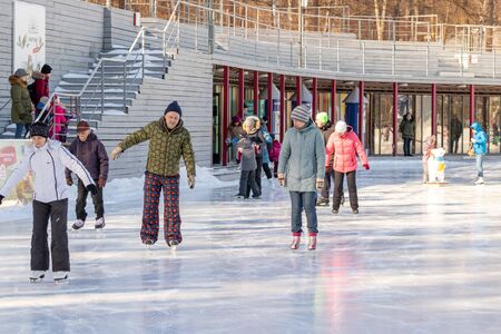 MOSCOW, RUSSIA- MARCH 02, 2019: People wearing winter clothes skating on a winter skating rink, family leisure and sport activity on christmas vacations and holidays.のeditorial素材
