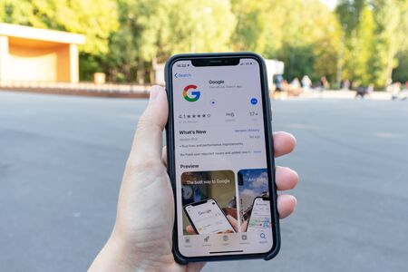 MOSCOW, RUSSIA - SEPTEMBER 01, 2019: Hand holding a smartphone with google application icon on...