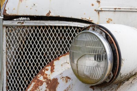 Headlight of an old rusty abandoned car, utilisation and scrap concept.の写真素材