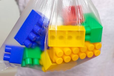 Colorful toy bricks, blocks for constructing and building in a plastic bag, package.
