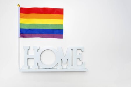 Lgbt rainbow gay pride flag and a sign home on white background.の写真素材