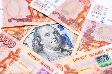 American us dollars lying among russian rubles, saving money from devaluation concept.