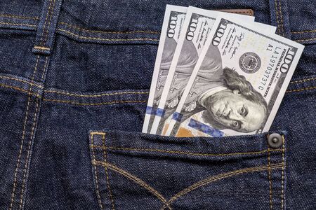 American us one hundred dollar banknotes in a pocket.