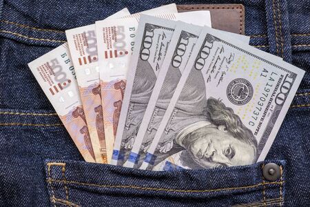 Russian rubles and us american dollars in a jeans pocket.