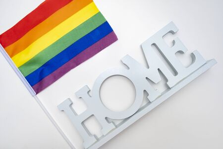 Lgbt rainbow gay pride flag and a sign home on white background.の写真素材