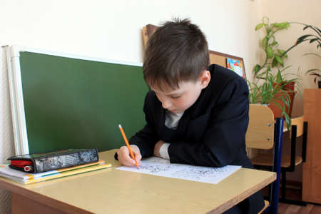 Moscow, Russia - September 1, 2017: Schoolboy, pupil sitting at the desk in class at school, traditional learning, offline education form, Day of knowlege in Russian school.のeditorial素材
