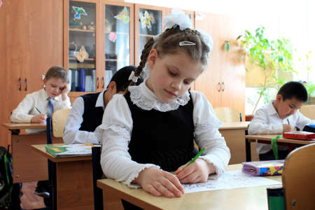 Moscow, Russia - September 1, 2017: Schoolgirls sitting at the desk in class at school, traditional...