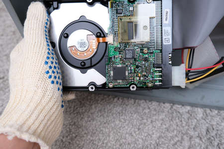 Moscow, Russia - September 10, 2020: Engineer changing the hard drive of an office computer,...