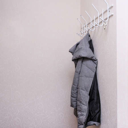Wintercoat hanging on a hook in a corridor, hallway at the entrance.の写真素材