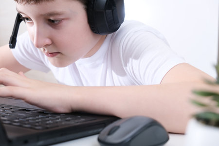 A boy playing online games on laptop, cyber sport concept.の写真素材