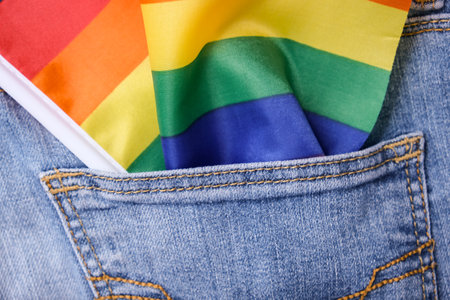 An lgbt rainbow flag in a jeans pocket, gay pride and tolerance concept