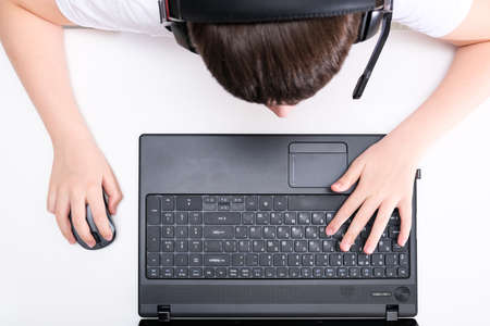 A boy playing online games on laptop, cyber sport concept.