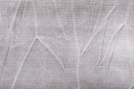 Gray shabby jeans denim background, texture of grey denim close up