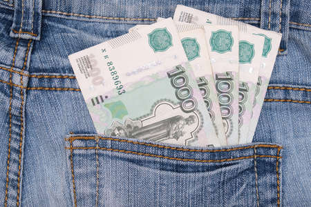 Paper 1000 banknotes of russian rubles in a jeans pocketの写真素材