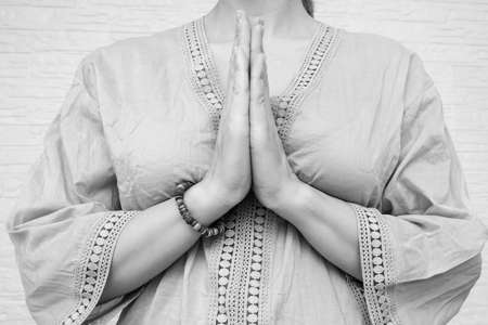 Woman ethnic clothes hold hands together is symbol prayer and gratitude, wai or namaste gesture, sign of thankfulness and and greeting, black and whiteの写真素材