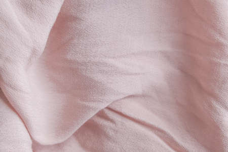 Natural nude gentle pink, light pastel textile cloth background, crumpled wavy textureの写真素材