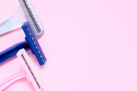 Different female plastic disposable razir blades on pink background with copy spaceの写真素材