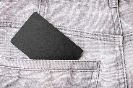 Black blank card with copy space in grey jeans denim pocketの写真素材