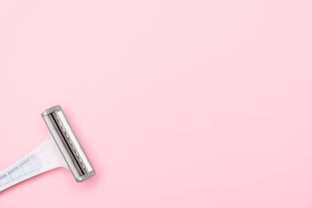 Grey female plastic disposable razir blades on pink background with copy spaceの写真素材