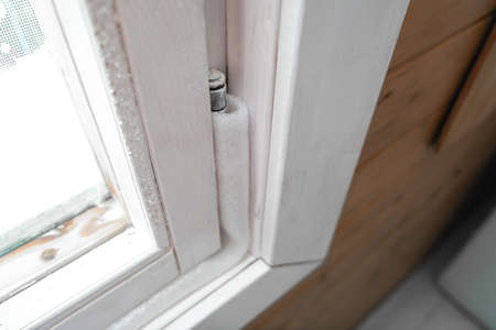 Insulated old window frames to prevent warmth heat leak and drafts, preparing house for winter and...