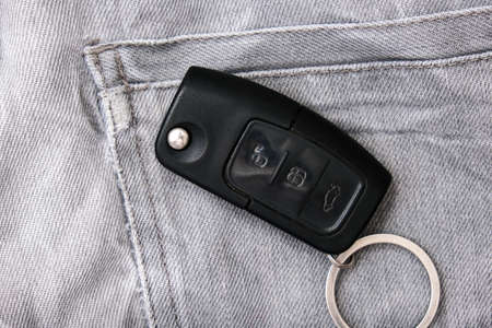 Car key, engine ignition key left on jeans after coming home, weak security, high probability of the car being stolen.の写真素材