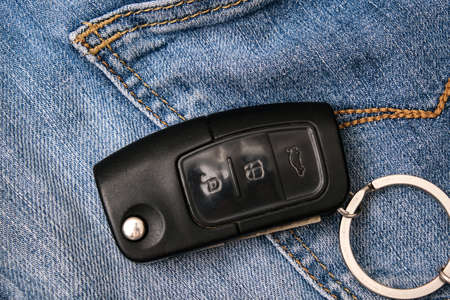 Car key, engine ignition key left on jeans after coming home, weak security, high probability of the car being stolen.の写真素材