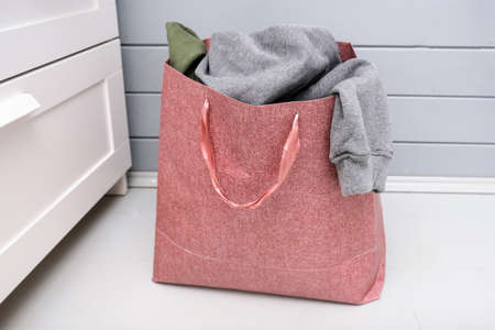 Paper bag full of old used clothes for donation and charity, recyclind and reusing clothesの写真素材