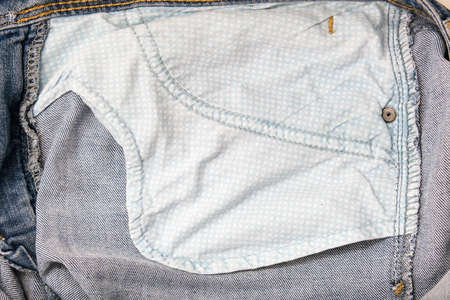 The wrong side, fabric of jeans denim pocket close up, reverse and back side of clothesの写真素材