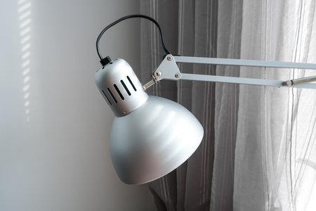 Modern flexible desk lamp for lighting workspace in office or home for freelancer, contemporary minimalistic interior designの写真素材