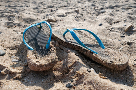 Flipflop sandals on the beach in a sand, travelling and resort conceptの写真素材