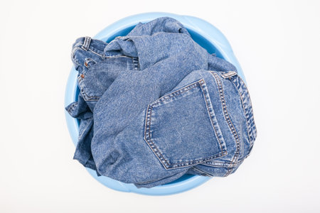 Jeans pants, denim in a bowl prepared for delicate hand washing, laundry conceptの写真素材
