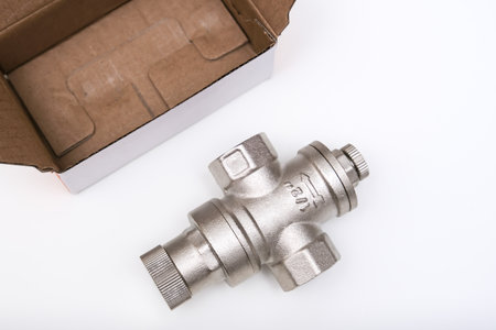 Water flow regulator, pressure reducer valve on white background, new repair part for plumbing,...