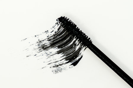 Smudged mascara texture, swatch of a brush on white backgroundの写真素材