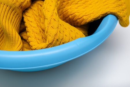 Hand washing of delicate woolen knitted clothes, sweaters concept, care of bright color clothesの写真素材