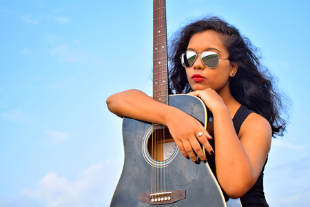 Young Indian girl with guitar, Puneの写真素材