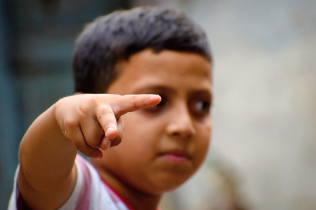 Young boy pointing. Pune, Maharashtraの写真素材