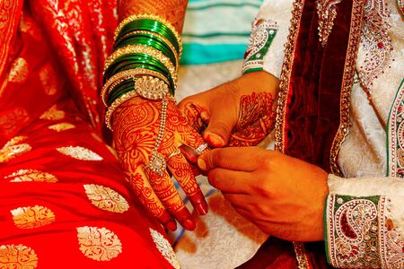 Engagement ring exchange, a ritual which takes place before Hindu weddingの写真素材