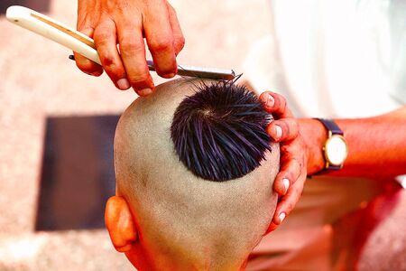 Getting a hair-cut for thread ceremony, Upanayana, a Hindu ritualの写真素材