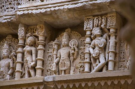 Carved idols on the inner wall and pillars of Rani ki vav, an intricately constructed stepwell on the banks of Saraswati River. Memorial to an 11th century AD King Bhimdev I. Built as inverted Vishnu temple with seven levels of stairs and holds more than 500 principal sculptures. Patan in Gujarat, India.の写真素材