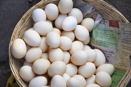 Fresh eggs in cane basketの写真素材