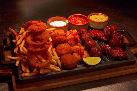 Fried Chicken Strips, Chicken Wings, Onion Rings, Fish Sticks And French Fries Sharing, Pune, Indiaの写真素材