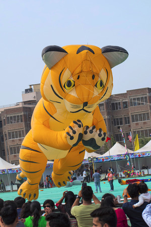 Various kites competing at the International Kite Festival at Sabarmati Riverfront, Ahmedabad, Gujarat, Indiaのeditorial素材