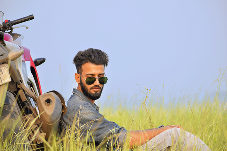 Indian Boy posing with motorbike at Pune, Maharashtraの写真素材